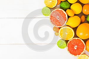 Various citrus fruit on the white wooden table