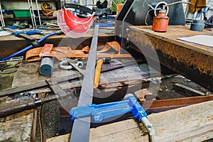 various clamps and devices at the workplace of a locksmith-welder