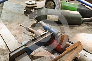 various clamps and devices at the workplace of a locksmith-welder