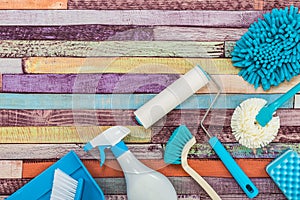 Various cleaning tools placed on a colorful table