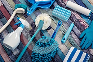 Various cleaning tools placed on a colorful table