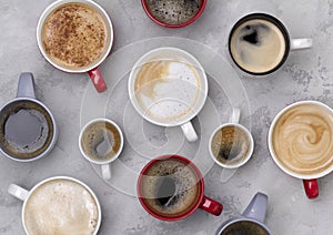 Various coffee in different cups on the concrete gray background