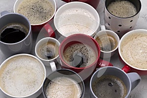 Various coffee in different cups on the concrete gray background