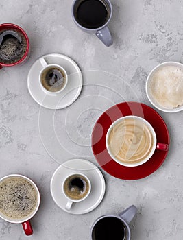 Various coffee in different cups on the concrete gray background