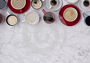 Various coffee in different cups on marble background. Flat lay top view composition
