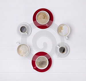 Various coffee in different cups on white wooden background