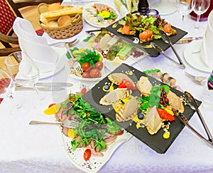 Various cold appetizers on the buffet: seafood, vegetables, meat, delicacies