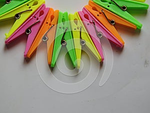 Various color background of Cloth hanging plastic clips  on white background