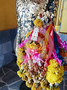 Various color of garland on Buddha statue, Thailand