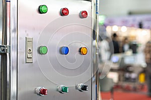 Various color select switch and push button lamp switch on off start stop at electric control cabinet for industrial