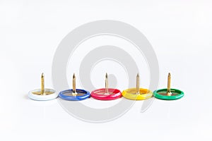 Various color thumbtack or pushpin in a row on white background