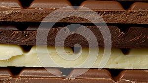 Various colored bars of chocolate layered on top of each other as a close-up