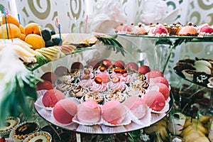 Various colored delicious sweets in a candy bar at a wedding. Sweet table. Wedding buffet.