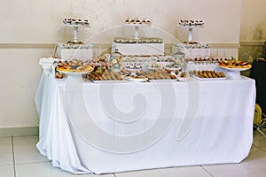 Various colored delicious sweets in a candy bar at a wedding. Sweet table. Wedding buffet