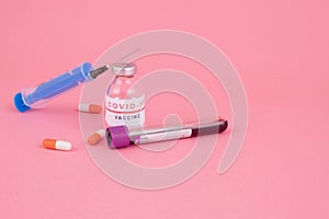 Various colored drugs, syringe and needle, vaccination against coronavirus COVID-19