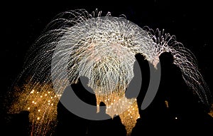 Various colored fireworks with silhouette of people.