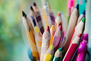 Various colored pencils in the glass, selective focus