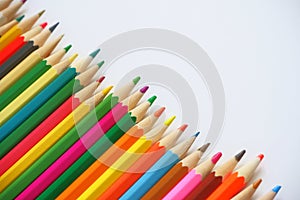 Various colored pencils on a white background.