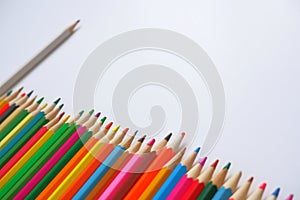 Various colored pencils on a white background.