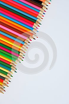 Various colored pencils on a white background.