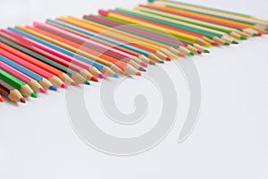 Various colored pencils on a white background.