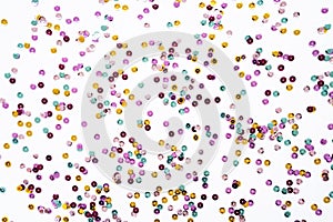 Various colored sequins on a white background