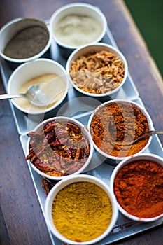 Various colored spices in recipients