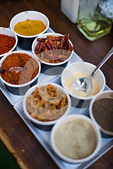 Various colored spices in recipients