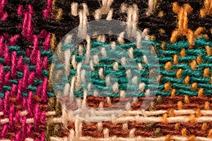 Various colored wool threads tissue pattern macro closeup