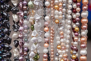 Various colorful beads in the market. Wallpaper background of a colorful necklace made of precious stones and colored beads