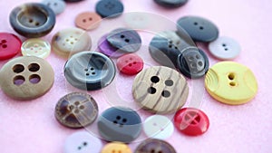 Various colorful buttons on pink rotating table