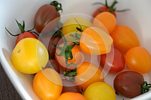 Various colorful cherry tomatoes in a plate