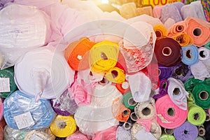 Various colorful fabric silk cotton rolls and synthetic fibers or rayon in textile shop industry from india
