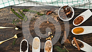 Various colorful herbs and spices on wooden table. Top view of spices and herbs. Spices and herbs over on wooden table background