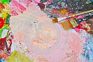 Various colors of paint with paint brushes, multi colored abstract oil paint stains background, bright colors painting copy space