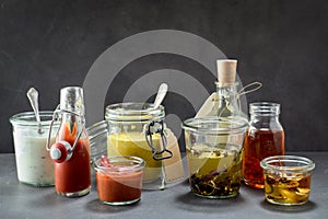 Various condiments in jars and bottles