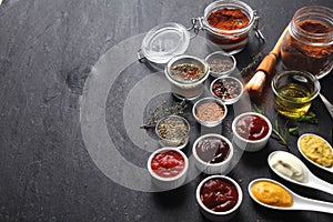 Various Condiments on Table with Copy Space photo