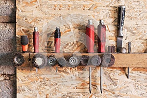 Various construction tools are hanging on the osb board