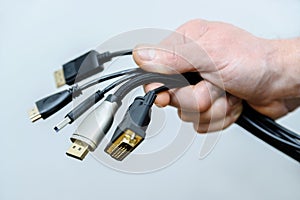The various cords and plugs in the hand.