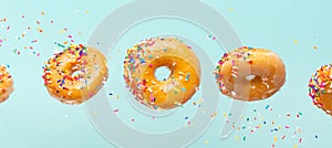 Various decorated donuts in motion falling on a blue background. Sweet and iced donuts fall or fly in motion. With caramel.