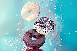 Various decorated doughnuts in motion falling Sweet and colourful donuts
