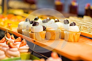 Various dessert on display in bakery shop photo