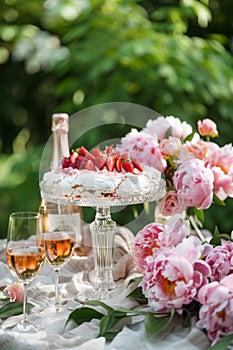 Various desserts and sparkling wine on a beautifully decorated outdoor table.