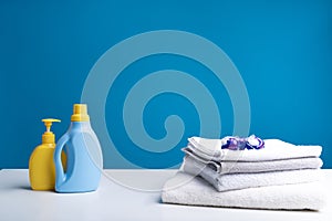 Various detergents and clean laundry lying on table