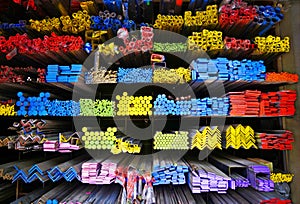 Various different series of metal tube and iron pipe stack on shelf at warehouse storage