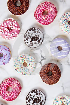 Various donuts on a colorful background. Top view shot.