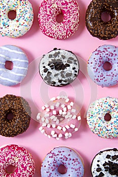 Various donuts on a colorful background. Top view shot.