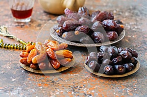 Various of dried dates or kurma in a vintage plates and tea