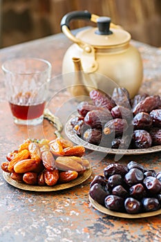 Various of dried dates or kurma in a vintage plates and tea