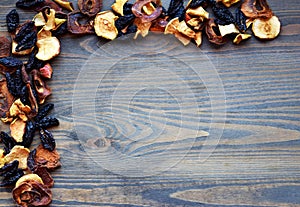 Various dried fruit displayed on an old wooden table.